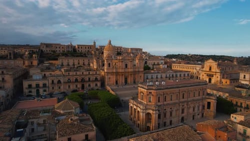 Noto, Sicily at sunset. San Nicolò Cathedral, baroque old town, warm evening light. Aerial drone 4K