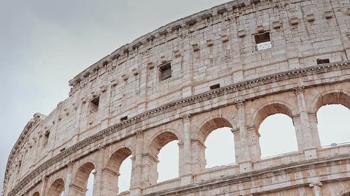 Facade of Colosseum Ancient Iconic Amphitheater Massive Arches Warm Sunlight on Historic Walls of