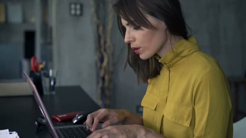 Young, Creative Businesswoman Working On Laptop Sitting By Table At Home Office