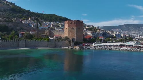 Red Tower Fortress in Alanya with Medieval Walls Stretching Along the Turquoise Coastline