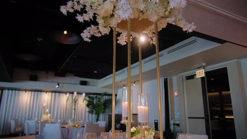 Close Up Footage of Restaurant Filled with Tables and Chairs and Candles on Them Wedding Event