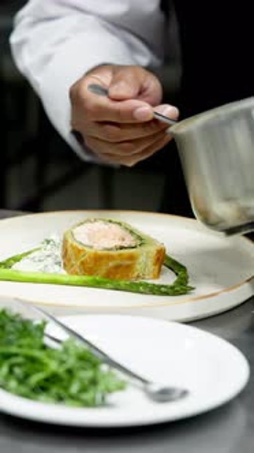 Chef Plates Salmon Dish with Creamy Sauce