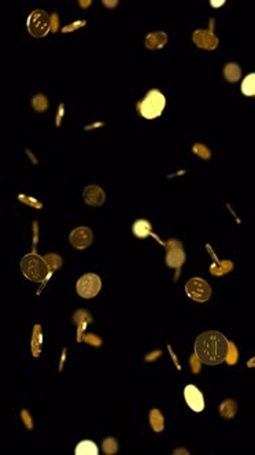 Golden Falling Bitcoins with soft focus.
