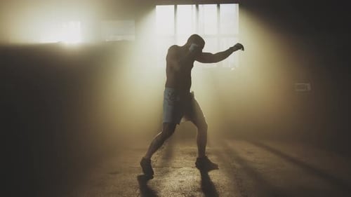 Practising shadow boxing at warehouse