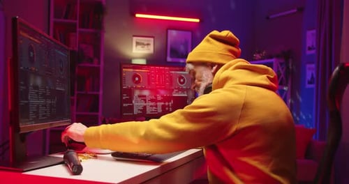 Close Up of Modern Caucasian Senior Audio Engineer Working in Music Recording Home Studio at Night