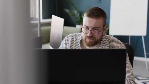 Bearded Man Working on Desktop Computer