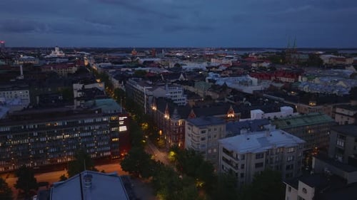 Aerial View of Down Development in Urban Borough at Dusk Revealing Wide Boulevard Lined By Trees