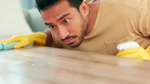Man Cleaning Table at Home