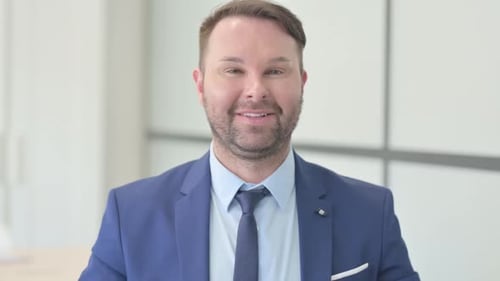 Confident Man in Suit Speaking to Camera