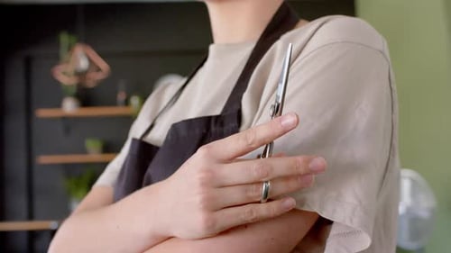Hairstylist Holding Scissors with Arms Crossed Close Up