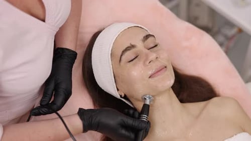 Woman Receiving Facial Treatment in Beauty Clinic