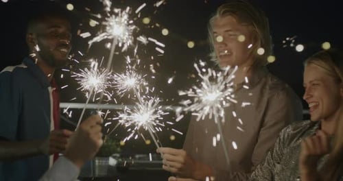Friends Celebrating at Night with Sparklers
