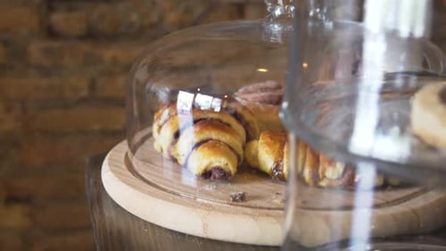 Freshly Baked Bread And Cookies On Rack With Glass Cover. - close up
