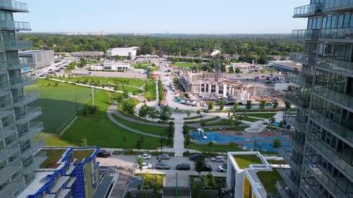 New residential housing units under construction in condominium development with urban park and land