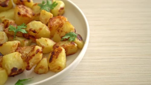 Golden Roasted Potatoes Glistening on a White Plate