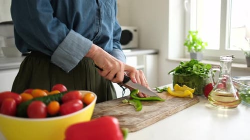 Woman Slicing Green Pepper