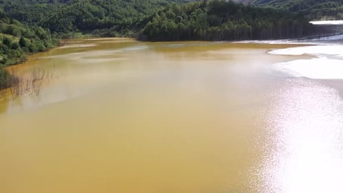 Flying above decanting lake, toxic residual drainage waters from copper mine aerial