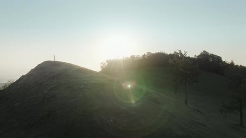 Young couple walking on the hill in the green countryside.