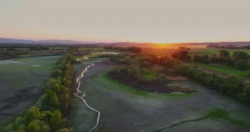 View of the River and the Forests Around During Sunset