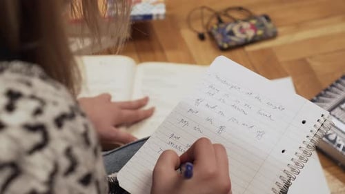 Student Taking Notes on Floor at Home