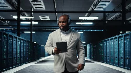 Server Room Programmer Wearing Headphones Troubleshooting Errors