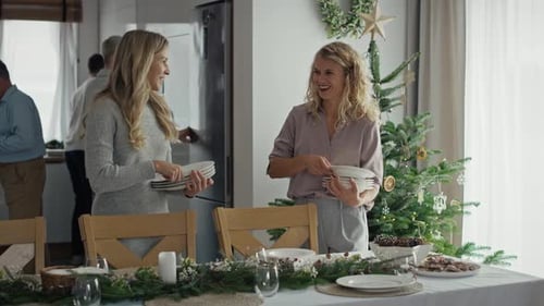Women Prepare Christmas Table for Family Gathering