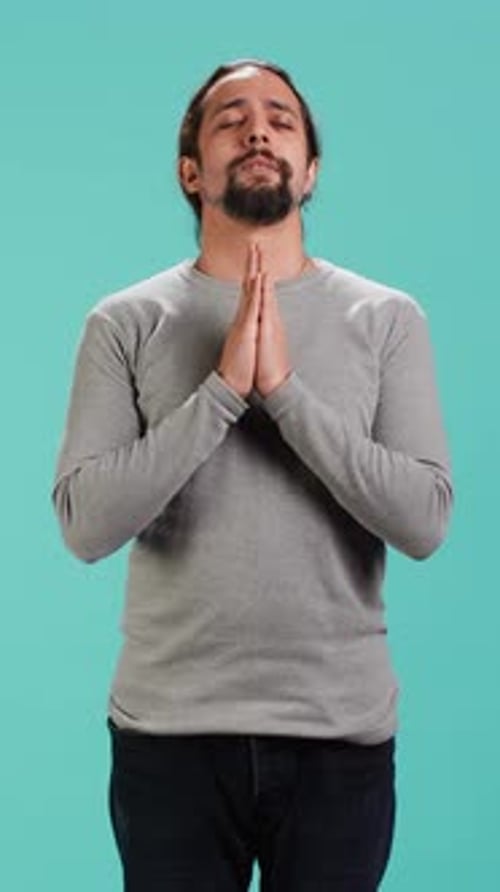 Man Praying With Hands Clasped in Vertical Video