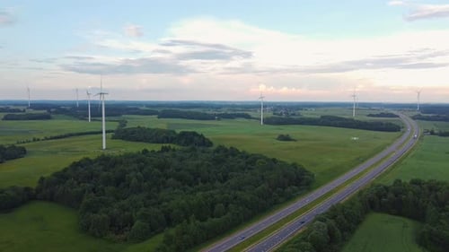 Highway road and wind turbines farm, aerial view
