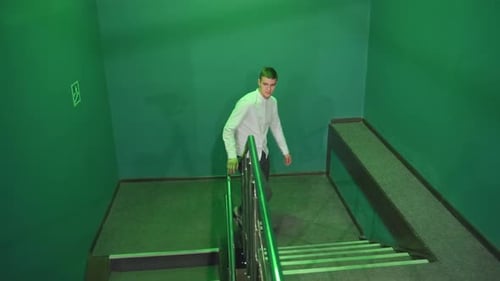 Young Man Walking Down Stairs in Urban Setting