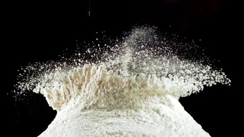 The Super Slow Motion of the Fresh Egg Falls Into the Pile of Flour Filmed on a Highspeed Camera at