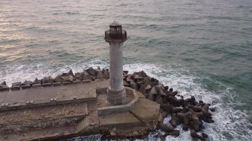Flying Around the Lighthouse on a Drone Early in the Morning at Sunrise