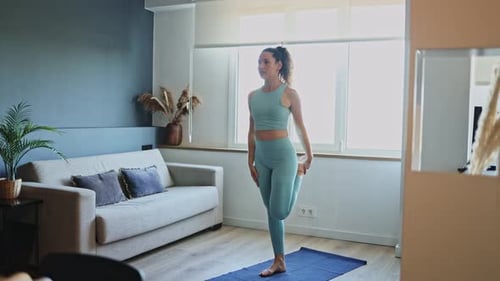 Woman Doing Yoga and Stretching Indoors
