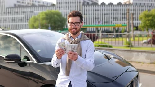 Man with Money By a Luxury Car