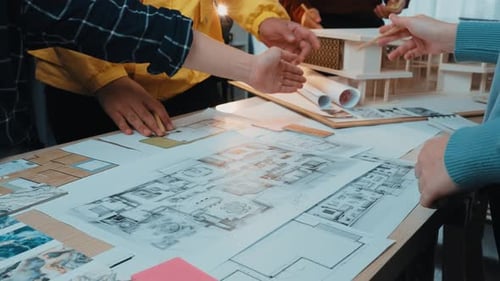 Architects Collaborate on Building Design Plans and Model