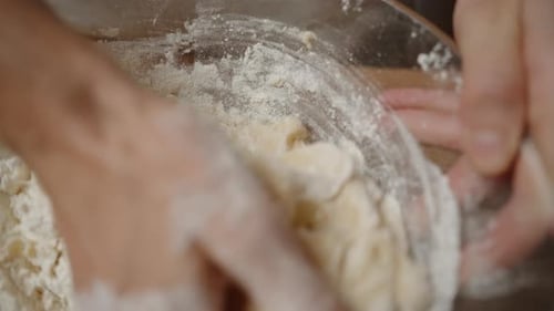 Hands Kneading Dough in a Glass Bowl, Combining Flour and Wet Ingredients, Creating a Smooth.