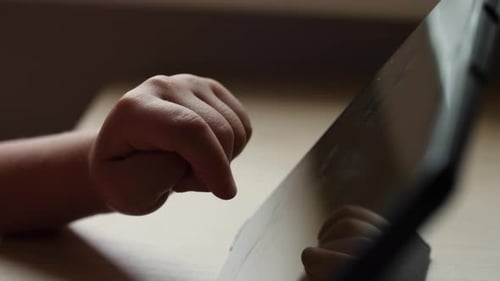 Closeup of Child Playing a Game on a Tablet Finger Tapping