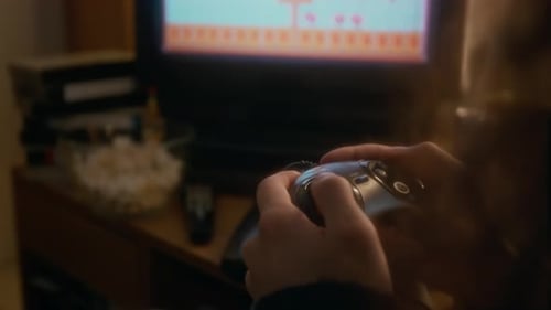 Hands Play Retro Video Game at Home