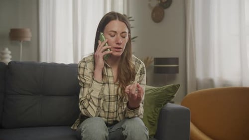 Woman Talking on Smartphone in Living Room