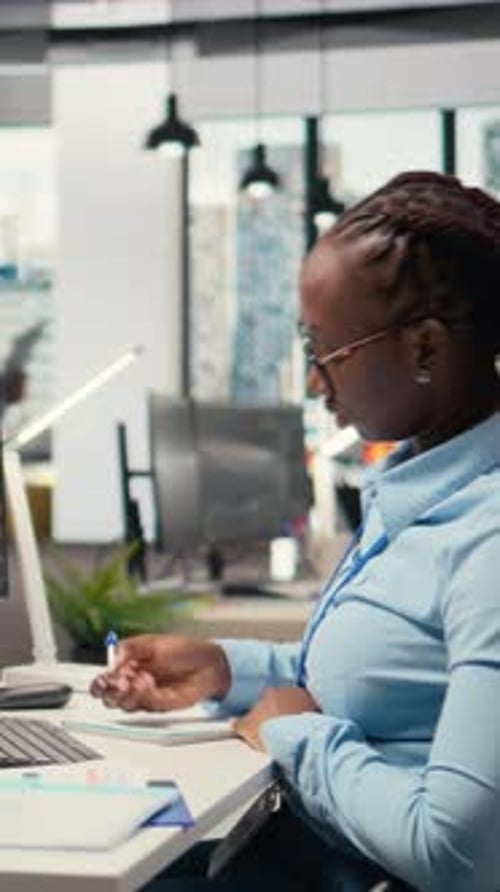 Vertical Video Equity Analyst in Prop Firm Office Reviews Quarterly Earnings Taking Notes