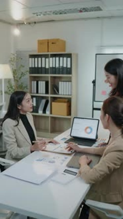 Businesswomen Collaborating on Data Analysis in Modern Office