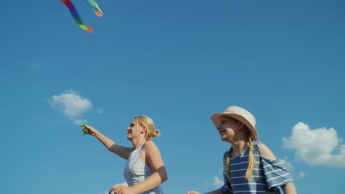 Mother and Child Playing With a Kite Outdoors