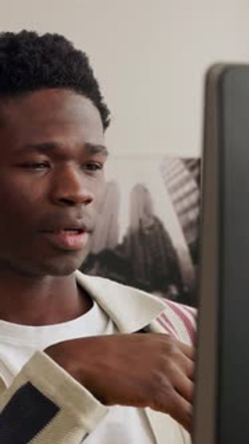 Young African Man Using Computer and Having a Video Call From Home Office