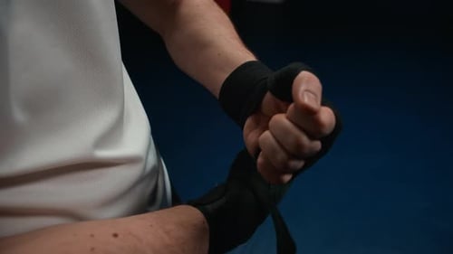 Close Up of Boxer Using Hand Wraps Before Sparring in Ring