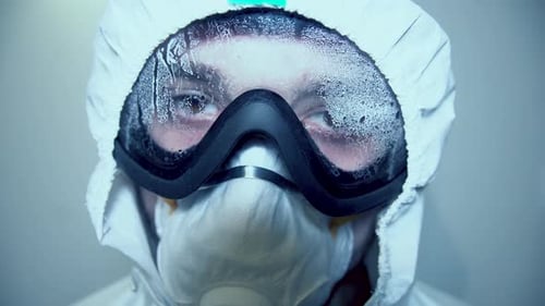 Close Up of Person Wearing Hazmat Suit and Mask