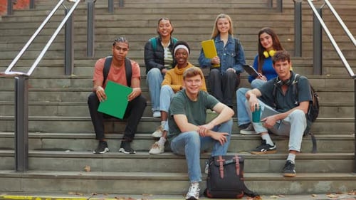 Diverse Group of University Students Smiling on Campus Stairs