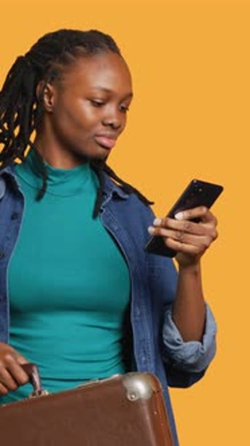 Vertical Video Smiling Girl Going on Vacation with Suitcase Reading Texts Studio Background