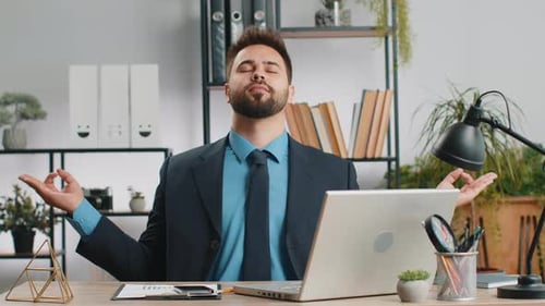 Businessman Working on Laptop Meditating Doing Yoga Breathing Exercise in Lotus Position at Office