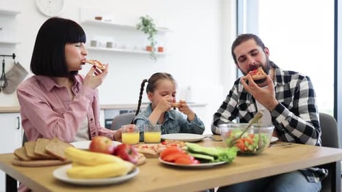 Family Together Eating Pizza at Home