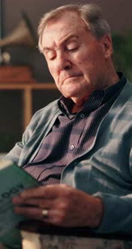 Senior Man Reading a Book Indoors