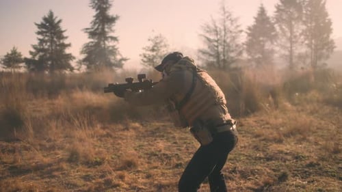 SOLDIER SHOOTING AR TYPE RIFLE AND PISTOL IN SLOW MOTION IN THE FOREST